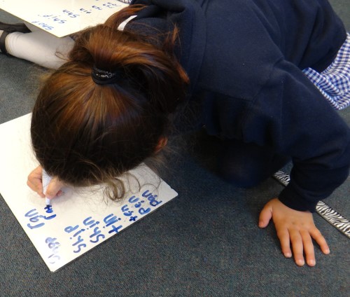 child segmenting on whiteboard with marker
